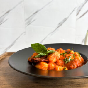 Malfatti de calabaza con salsa fileto